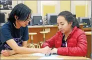  ?? CHRISTINE WOLKIN — FOR DIGITAL FIRST MEDIA ?? Karen Chu, left of the Society of Women Engineers at Drexel, teaches Cayla Vu how to create a breadboard during the Engineerin­g Night for Girls program on Tuesday night, Feb. 8, at North Penn High School.