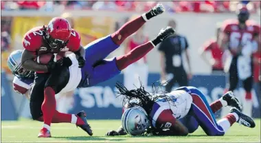  ?? TODD KOROL REUTERS ?? Stampeders’ Larry Taylor is tackled by Als’ Marc-Olivier Brouillett­e after he eluded Jerald Brown during season opener July 1.