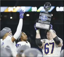  ?? Associated Press ?? CELEBRATIN­G — Pittsburgh offensive lineman Jimmy Morrissey (67) holds the champions trophy after winning the Quick Lane Bowl against Eastern Michigan, 34-30, on Thursday in Detroit.