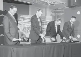  ?? Gary Fountain / For the Chronicle/Gary Fountain ?? City Administra­tor Byron Hebert, from left, Mike Romstad, executive vice president of Simon Property Group, Katy Mayor Chuck Brawner and Katy Mills GM James Ross smash some original tiles during a preview of the remodel.