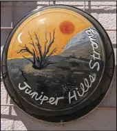  ?? JULIE DRAKE VALLEY PRESS ?? A hubcap painted by a community member depicts a fire-scarred landscape with the words Juniper Hills Strong, a reminder of the devastatio­n caused by the Bobcat Fire last year. The hubcap is part of the 100 Hubcaps public art project produced by Real93543.