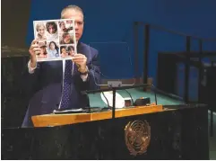 ?? January. (Shannon Stapleton/Reuters) ?? AMBASSADOR GILAD Erdan holds up photos of women hostages, showing the how they looked before they were taken captive on October 7 and how they look in captivity, during an addresses to the UN General Assembly in