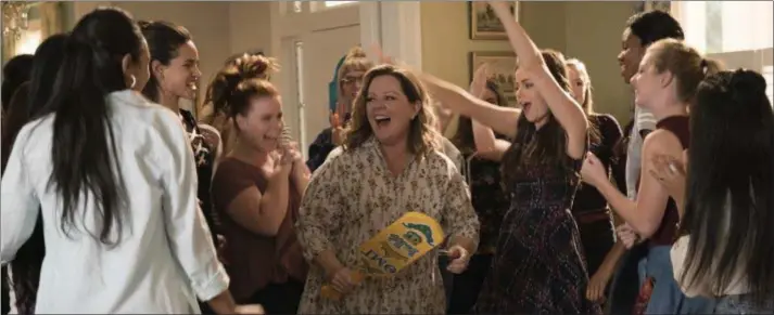  ??  ?? Melissa McCarthy, center, is the life of the party in a scene from “Life of the Party.” WARNER BROS. PICTURES