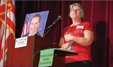  ?? DIGITAL FIRST MEDIA FILE PHOTO ?? Tammy Harkness, an organizer of a Feb. 25town hall meeting at Phoenixvil­le Area High School fromthe Concerned Citizens Community Action Group, stands next to a photo of Congressma­n Ryan Costello, who was invited to the meeting but could not attend...