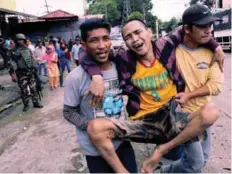  ??  ?? A Marawi resident is evacuated from the city yesterday.