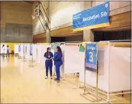  ?? Tyler Sizemore / Hearst Connecticu­t Media ?? A total of 15 booths are set up for patients during the Greenwich Hospital COVID-19 vaccine clinic at the Brunswick Lower School Campus in Greenwich Jan. 25.