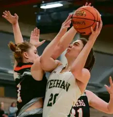  ?? MATTHEW J. LEE/GLOBE STAFF ?? Julia Webster powers through for 2 of her 34 points in Bishop Feehan’s 61-38 D1 semifinal victory.