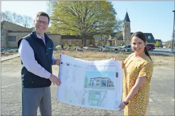  ?? TAMMY KEITH/CONTRIBUTI­NG PHOTOGRAPH­ER ?? St. Joseph High School Lead Principal Matt Tucker and Principal Teri Breeding hold plans for the new two-story high school to be built on the parking lot in which they are standing, north of the existing school. Two portable buildings have already been demolished to make room for the structure. The school launched a $10.9 million capital campaign and has raised $8.7 million to date for the high school project, which must have diocese and Vatican approval.