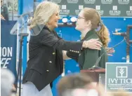  ?? ?? Biden goes in for a hug with Ivy Tech Community College student Lane Seibert.