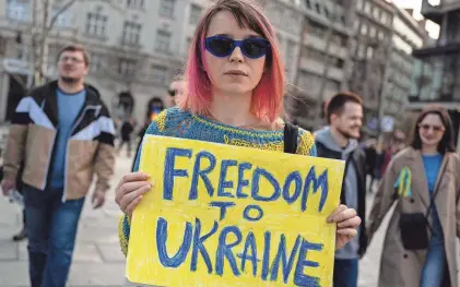  ?? ANDREJ ISAKOVIC/AFP VIA GETTY IMAGES ?? Protesters in Belgrade, Serbia, on Friday mark one year since the invasion of Ukraine by Russia. The White House announced Friday the Pentagon would commit $2 billion for the fight against Russia.