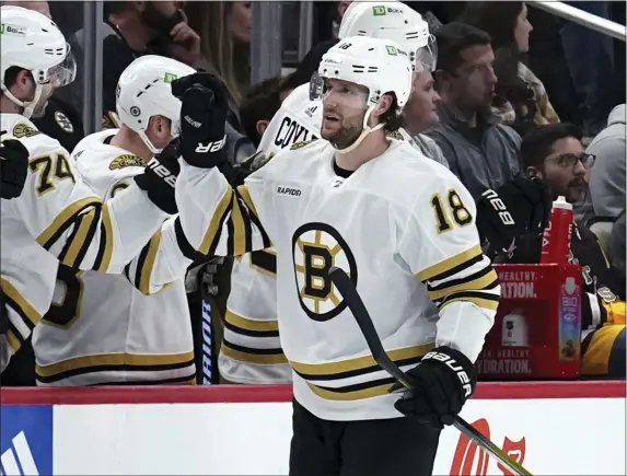  ?? MATT FREED — THE ASSOCIATED PRESS ?? Boston Bruins forward Pavel Zacha returns to the bench after scoring against the Pittsburgh Penguins during the second period. The Bruins skated to a 6-4 victory.