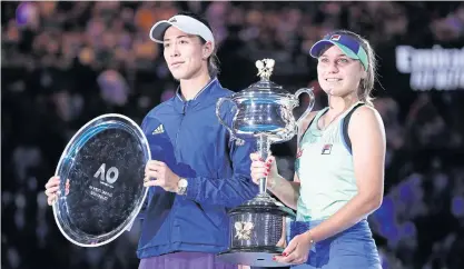  ??  ?? Champion Kenin, right, and runner-up Muguruza pose with their trophies after the final.