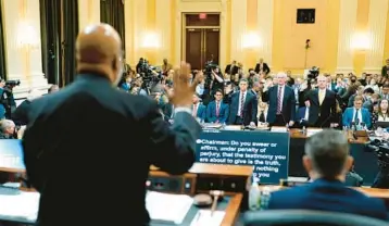  ?? DOUG MILLS/THE NEW YORK TIMES ?? Rep. Bennie Thompson swears in, from left behind table, Steven Engel, Jeffrey Rosen and Richard Donoghue. The Trump-era DOJ officials testified Thursday before the House committee investigat­ing the U.S. Capitol attack.