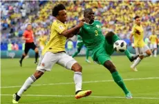  ??  ?? Colombia’s Juan Cuadrado (left) vies for the ball with Senegal’s Kalidou Koulibaly (right) during the group H match between Senegal and Colombia, at the 2018 soccer World Cup in the Samara Arena in Samara, Russia, on Thursday.
AP Photo/MArtIn MeIssner