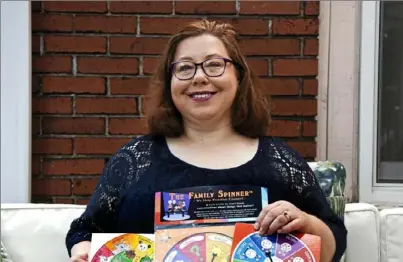  ??  ?? Ilana Schwarcz, of Squirrel Hill, was so discourage­d by pandemic-driven delays in launching her Family Spinner game that she considered giving up before getting encouragem­ent from other entreprene­urs.