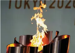  ?? (Reuters) ?? THE CELEBRATIO­N CAULDRON is lit during a torch kiss event at the Tokyo 2020 Olympic torch relay celebratio­n at Shiba Park yesterday ahead of today’s opening ceremony.