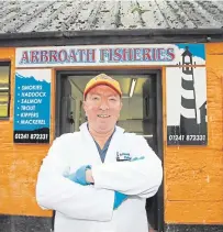  ??  ?? Clockwise: Campbell Scott shows off some of the top quality seafood Arbroath Fisheries handles. Campbell outside his distinctiv­e shop and smokehouse. A rack of smokies over a fire pit.