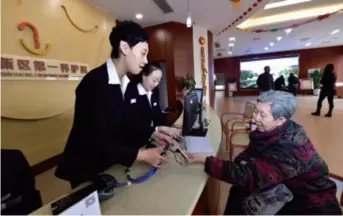  ??  ?? An elderly woman checks into a nursing home in Tianjin Binhai New Area on March 25