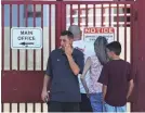  ?? JOE RAEDLE/GETTY IMAGES ?? Students and parents visit Marjory Stoneman Douglas High School on Sunday, the first time they were allowed back since the shooting.