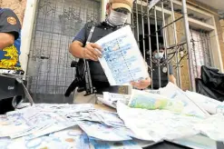  ?? —INQUIRER PHOTO ?? LOOK ALIKE In this December 2020 file photo, fake 1,000 peso bills were seized from three men who were printing them inside an apartment in Manila after a raid by police and personnel of the Bangko Sentral ng Pilipinas.