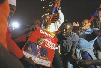  ?? Brian Inganga / Associated Press ?? Supporters of President Uhuru Kenyatta hold posters and blow vuvuzela noisemaker­s as they await the announceme­nt of election results at a downtown conference center in Nairobi.