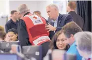  ?? SUSAN WALSH/ASSOCIATED PRESS ?? Vice President Mike Pence, center, speaks with workers during a visit to FEMA headquarte­rs in Washington on Sunday to observe the response to Hurricane Irma.