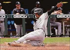  ?? Charlie Riedel / Associated Press ?? The Yankees’ Isiah Kiner-Falefa slides home to score on a single by DJ LeMahieu against the Royals during the fifth inning Sunday.