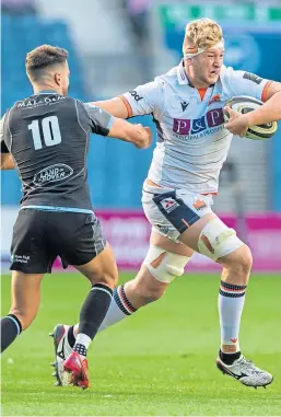  ?? Picture: SNS. ?? Edinburgh’s Jamie Hodgson, right, holds off Glasgow Warriors’ Adam Hastings during last weekend’s win for the capital side.