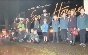  ??  ?? Delivery Scouts from Dunning Scout Group, 26th Perthshire with butcher boss Simon Howie delivering food for the over 80s dinner to many houses around Dunning