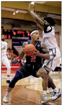  ?? AP/MARCO GARCIA ?? Auburn’s Bryce Brown tries to shoot over Xavier’s Quentin Goodin during the first half Monday at the Maui Invitation­al in Lahaina, Hawaii. Brown led the Tigers with 26 points, including five in overtime, in an 88-79 victory.