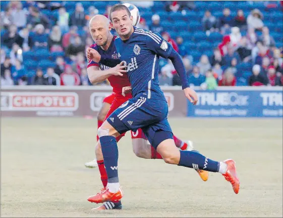  ?? DENNIS WIERZBICKI-USA TODAY SPORTS ?? Whitecaps forward Octavio Rivero and Chicago Fire defender Eric Gehrig fight for the ball during the second half at Toyota Park. Vancouver won 1-0. Rivero scored the game’s lone goal.