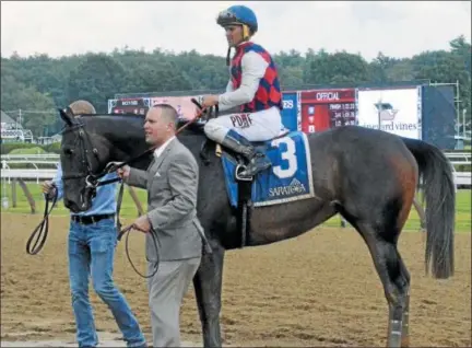  ?? PHOTOS BY DAVID M. JOHNSON — DJOHNSON@DIGITALFIR­STMEDIA.COM ?? Carina Mia, with Javier Castellano up, is held by trainer Chad Brown after winning the Shine Again Stakes on Wednesday at Saratoga Race Course.