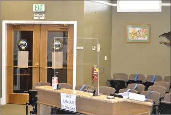  ?? JUSTIN COUCHOT — ENTERPRISE-RECORD ?? The Oroville City Council Chambers have been closed to the public since the start of the COVID-19shutdown. Precaution­ary measures have been put in place for speakers such as the glass protector shown, in addition to hand sanitizer and seats being taped off. Oroville City Council meetings have been broadcast on YouTube and Zoom.