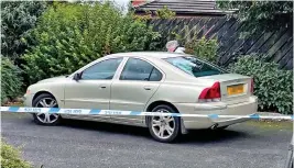  ?? ?? Investigat­ion: A Volvo is cordoned off and examined by officers