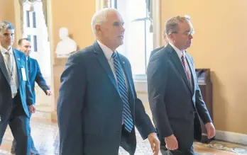  ?? J. SCOTT APPLEWHITE/AP ?? Vice President Mike Pence and incoming White House Chief of Staff Mick Mulvaney (right) leave Saturday after conferring with Senate Majority Leader Mitch McConnell, R-Ky., at the Capitol in Washington.