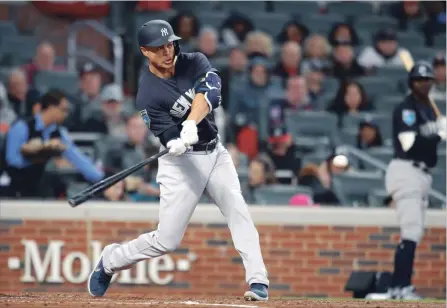  ?? ASSOCIATED PRESS FILE PHOTO ?? Yankees right fielder Giancarlo Stanton hits a two-run home run in a spring training baseball game against the Braves on Monday in Atlanta.