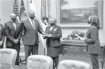  ?? DOUG MILLS/THE NEW YORK TIMES ?? Vice President Kamala Harris conducts a ceremonial swearing-in of Defense Secretary Lloyd Austin this week. President Biden picked nearly all of his Cabinet secretarie­s and their deputies before he took office.