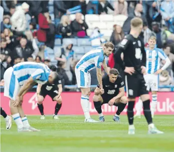  ?? ?? STALEMATE: Huddersfie­ld Town and Birmingham City players share their dejection after a 1-1 draw meant both sides dropped point in battle to avoid relegation. Town are down, will Birmingham join them?