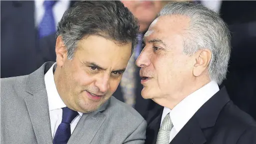  ?? AP ?? In this May 12, 2016 file photo, Brazil’s then acting President Michel Temer whispers into the ear of Senator Aecio Neves at the Planalto presidenti­al palace in Brasilia, Brazil. On Thursday, May 18, Brazilian federal police searched the office and...