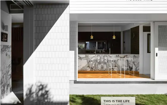  ??  ?? COURTYARD Gloss white tiles complement slabs of dolomite from SNB Stone. KITCHEN
Ciel Blanc dolomite benchtop, SNB Stone. Hee barstools, Cult. Artek A330S pendant lights designed by Alvar Aalto, Anibou. Winckelman­s wall tiles in Black, Metro Tiles. Blackbutt parquetry, Finlayson’s. Dempo cooktop, Pitt Cooking. Fridge, Mitsubishi Electric. Tap, Hansgrohe.