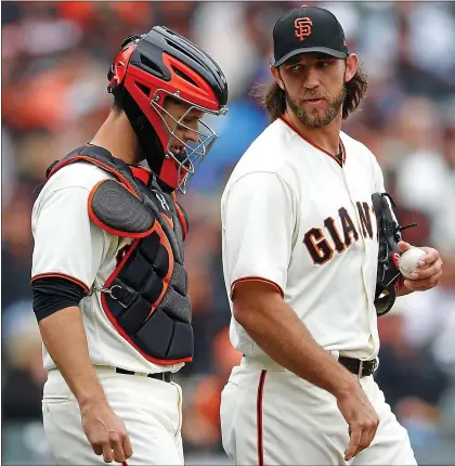  ?? JOSIE LEPE — STAFF PHOTOGRAPH­ER ?? The Giants hope Buster Posey, left, will catch 120games this season, and all signs point to Madison Bumgarner sticking around through camp.