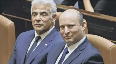  ??  ?? 0 Incoming PM Naftali Bennett (right) and alternate PM Yair Lapid in the Knesset chamber