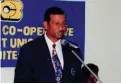  ??  ?? Norman Vickers, first chairman of the board at the podium addressing NCBECCU members at an AGM in 1995.