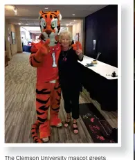  ??  ?? The Clemson University mascot greets Mainella at a U.S. Play Coalition conference in South Carolina.