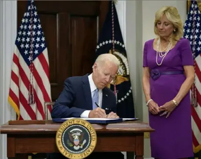  ?? Pablo Martinez Monsivais/Associated Press ?? President Joe Biden signs into law the Bipartisan Safer Communitie­s Act gun safety bill on June 25. First lady Jill Biden looks on.