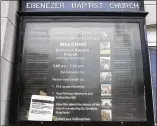  ?? ALYSSA POINTER / ALYSSA.POINTER@AJC.COM ?? A sign informing visitors that the site is closed is taped inside the bulletin board outside of the historic Ebenezer Baptist Church at the Martin Luther King Jr. National Historical Park in Atlanta on Thursday.