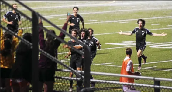  ?? AUSTIN HERTZOG - DIGITAL FIRST MEDIA ?? Erik Recke, center left, and Nik Verma lead the celebratio­n in front of the Boyertown fans after Recke scored the game-winning goal of the Bears’ semifinal win over Spring-Ford.