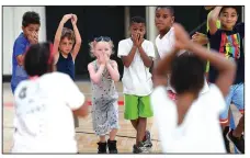  ?? NWA Democrat-Gazette/J.T. WAMPLER ?? Children play a resource-based game at the Summer Fun4Kids Camp at Yvonne Richardson Center. The program is designed to impact the lives of youth through a variety of activities focusing on health &amp; fitness, nature, outdoors and the Arts.