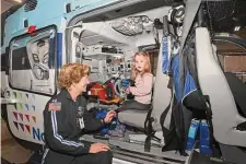  ?? Ned Gerard/Hearst Connecticu­t Media ?? Lola Whalen, a Registered Nurse from the SkyHealth helicopter crew, talks with 2-year-old Madilyn York during a tour inside the new helicopter in Stratford, Feb. 9.