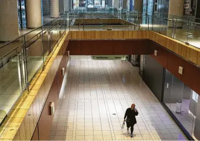  ?? Jon Shapley / Staff file photo ?? A woman walks through the Galleria before it reopened in May. Simon Property Group says masks still will be required for shoppers and employees at the Galleria and its other shopping centers despite Texas’ mask mandate being lifted.